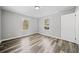 Well-lit bedroom with wood-look floors and two windows at 2131 Ben Hill Rd, Atlanta, GA 30344