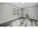 Bright dining area with gray walls, wood-look flooring, and kitchen access at 2131 Ben Hill Rd, Atlanta, GA 30344