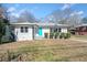 Newly renovated single-story home with a teal door and well-manicured lawn at 2131 Ben Hill Rd, Atlanta, GA 30344