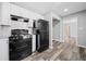 Modern kitchen with white cabinets, granite counters and black appliances at 2131 Ben Hill Rd, Atlanta, GA 30344