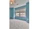 Light blue bedroom with carpeted floor and large window at 415 Royal Crescent E Ln, Canton, GA 30115