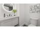 Stylish bathroom with a round mirror and modern vanity at 1167 Key Se Rd, Atlanta, GA 30316