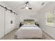 Bright bedroom with a queen bed and sliding barn doors at 1167 Key Se Rd, Atlanta, GA 30316