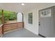 Front porch with modern wooden railings and gray door at 1167 Key Se Rd, Atlanta, GA 30316