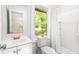 Clean bathroom with white vanity, shower, and window at 2905 Gresham Se Rd, Atlanta, GA 30316