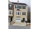 Tan three-story townhome with a white garage door and green front door at 805 Abbotts Mill Ct # 74, Duluth, GA 30097