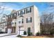 Tan townhome with green shutters and a white garage door at 805 Abbotts Mill Ct # 74, Duluth, GA 30097