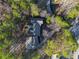 Home surrounded by lush trees with a circular driveway at 1053 Fairway Valley Dr, Woodstock, GA 30189