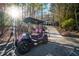 Pink and black golf cart in front of house for sale at 1053 Fairway Valley Dr, Woodstock, GA 30189