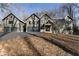 Modern farmhouse with gray siding, metal roof, and multiple garage doors at 1536 Bullard Rd, Powder Springs, GA 30127