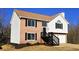 Two-story house with brick and vinyl siding, two-car garage, and a landscaped yard at 256 Kings Cv, Locust Grove, GA 30248