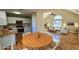 Open kitchen and dining area with hardwood floors and modern light fixtures at 256 Kings Cv, Locust Grove, GA 30248