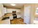 Kitchen with white cabinets, stainless steel appliances, and hardwood floors at 256 Kings Cv, Locust Grove, GA 30248
