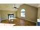 Spacious living room featuring hardwood floors, a fireplace, and a vaulted ceiling at 256 Kings Cv, Locust Grove, GA 30248
