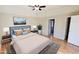 Main bedroom with hardwood floors, staged furniture, and access to bathroom at 256 Kings Cv, Locust Grove, GA 30248