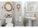 Elegant powder room with ornate mirror and pedestal sink at 3523 Weaver Falls Ln, Loganville, GA 30052