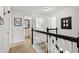 Upstairs hallway with neutral decor and access to bedrooms and bath at 3523 Weaver Falls Ln, Loganville, GA 30052