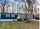 Newly painted blue house with white trim, landscaping, and a long driveway at 212 Valerie Cir, Hiram, GA 30141