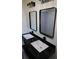 Bathroom featuring dual sinks with black trim and decorative lighting at 1988 Glenmar Dr, Decatur, GA 30032