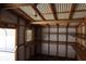 Interior of open carport showing metal construction and wooden shelves at 1988 Glenmar Dr, Decatur, GA 30032