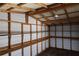 Bright interior of an empty carport featuring wooden frame and built in shelving at 1988 Glenmar Dr, Decatur, GA 30032