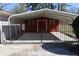 Enclosed carport in a fenced in back yard with space for parking and storage at 1988 Glenmar Dr, Decatur, GA 30032