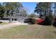 A single-story home with a manicured lawn, carport, and fenced backyard at 1988 Glenmar Dr, Decatur, GA 30032