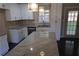 Well-lit kitchen featuring granite countertops, white cabinetry, and stainless steel appliances at 1988 Glenmar Dr, Decatur, GA 30032