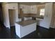 White cabinets, stainless appliances, and a granite island make this kitchen a dream at 1988 Glenmar Dr, Decatur, GA 30032