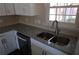 Modern kitchen sink with granite countertops and stainless steel faucet under bright window light at 1988 Glenmar Dr, Decatur, GA 30032