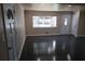 Inviting living room with polished dark hardwood floors and bright natural light from large window at 1988 Glenmar Dr, Decatur, GA 30032