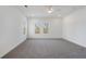 Well-lit bedroom with grey carpet and two windows at 364 Poplar Springs Rd, Hiram, GA 30141