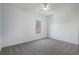 Bright bedroom with grey carpet, ceiling fan, and large window at 364 Poplar Springs Rd, Hiram, GA 30141