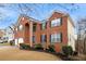 Brick two-story house with a two-car garage and landscaped yard at 7606 Forest Glen Way, Lithia Springs, GA 30122