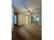 Bedroom featuring carpet flooring, ceiling fan, bathroom and large mirrored closet at 306 Hawkstone Way, Alpharetta, GA 30022