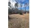 Wooded backyard with a storage shed, providing privacy and outdoor space at 6540 Old White Mill Rd, Fairburn, GA 30213