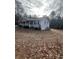 Side view of a Ranch style home showcasing the length of the house and backyard at 6540 Old White Mill Rd, Fairburn, GA 30213