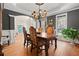 Bright dining room with hardwood floors, chandelier, and seating for six at 4095 Northridge Dr, Cumming, GA 30040