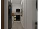 Modern galley kitchen with black appliances and white cabinets at 6305 Shannon Pkwy # 112, Union City, GA 30291
