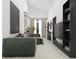 Spacious living room with green sofa and large TV at 6305 Shannon Pkwy # 112, Union City, GA 30291