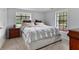 Cozy bedroom with a comfortable bed and wood nightstand at 10170 Cedar Grove Rd, Chattahoochee Hills, GA 30213