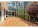 Large deck overlooking wooded backyard with flowering trees at 10170 Cedar Grove Rd, Chattahoochee Hills, GA 30213