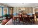 Elegant dining room with wood table and floral wallpaper at 10170 Cedar Grove Rd, Chattahoochee Hills, GA 30213