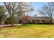 Ranch style brick home with manicured lawn at 10170 Cedar Grove Rd, Chattahoochee Hills, GA 30213