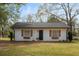 Charming white cottage with black shutters and landscaping at 10170 Cedar Grove Rd, Chattahoochee Hills, GA 30213