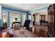 Living room with hardwood floors, a bay window, and views to other rooms at 10170 Cedar Grove Rd, Chattahoochee Hills, GA 30213