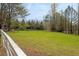 Green pasture with a white fence and trees at 10170 Cedar Grove Rd, Chattahoochee Hills, GA 30213