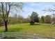 Serene pasture with a white fence and lush green grass at 10170 Cedar Grove Rd, Chattahoochee Hills, GA 30213