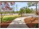 Landscaped yard with walkway leading to home at 10170 Cedar Grove Rd, Chattahoochee Hills, GA 30213