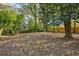 Spacious backyard with mature trees and leaves at 2930 Kimmeridge Dr, Atlanta, GA 30344